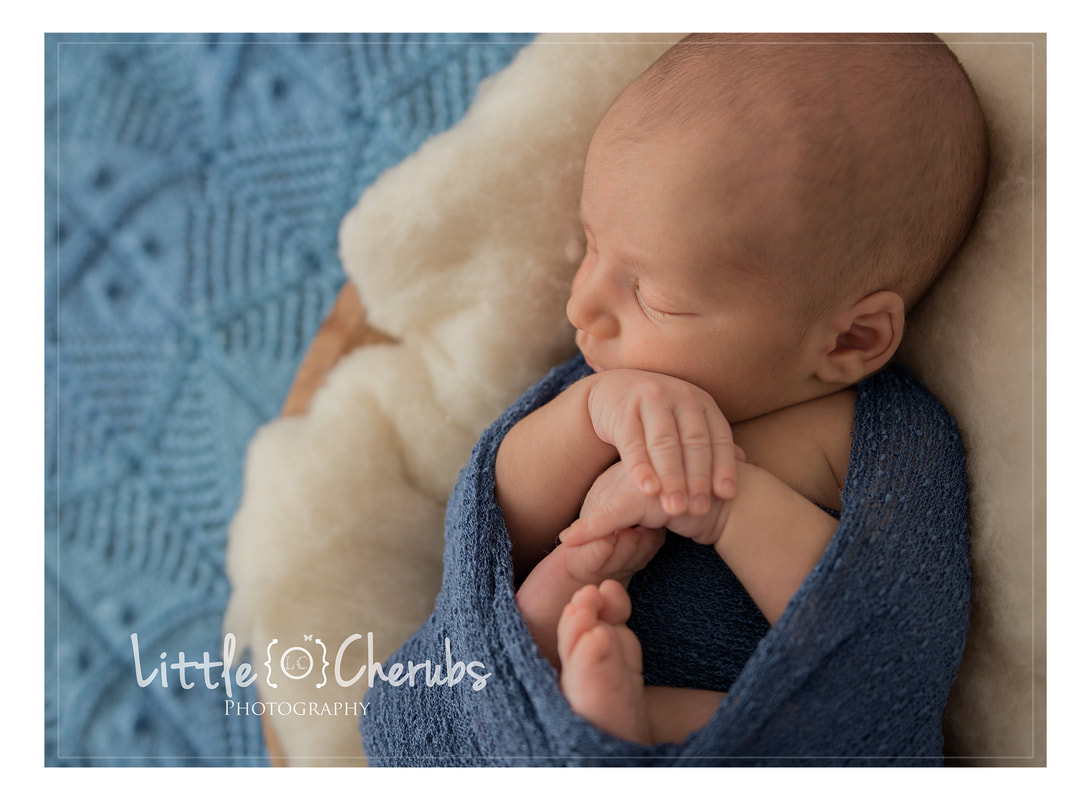 newborn in blue chatteris baby photographer