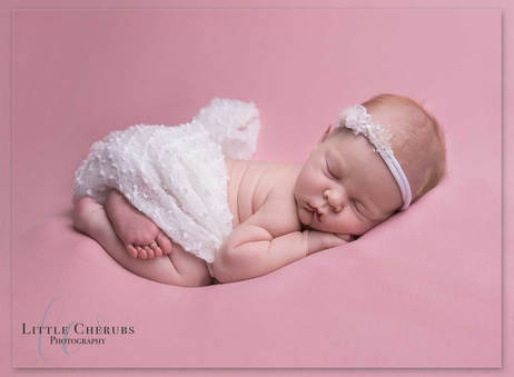 cute newborn baby girl asleep on her front in a white wrap march cambridgeshire photographer little cherubs photography