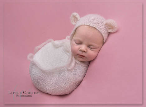 newborn baby girl in bear bonnet on pink backdrop little cherubs photography march peterborough ely