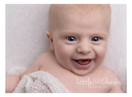 smiling newborn baby boy on white peterborough cambridge photographer