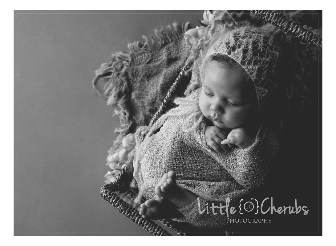 black and white newborn girl in bed with bonnet march cambridge photographer best near ely peterborough