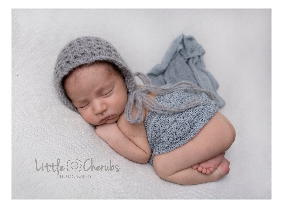 sleeping newborn baby in bonnet photographer near peterborough