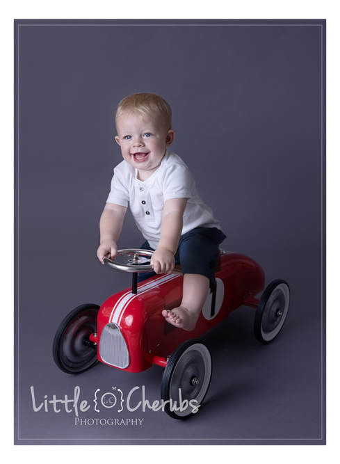 baby birthday photos on red racing car photography studio near march cambridge peterborough ely