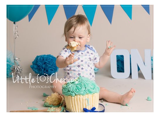 cake smash ely baby throwing cake at photographer